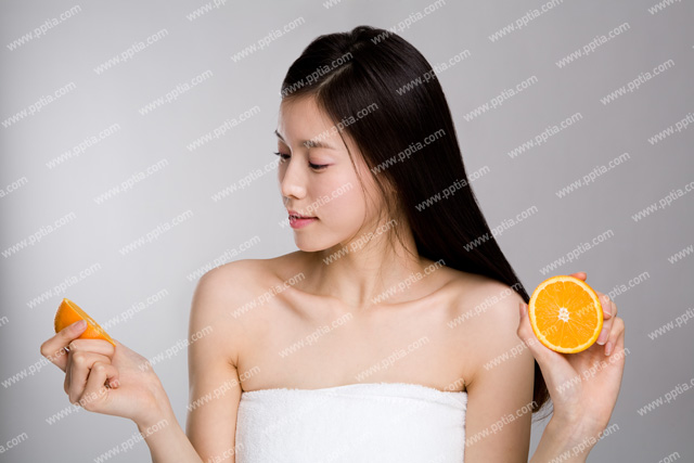 샤워 타올을 걸친 여성이 오렌지 들고 있는 모습 이미지 미리보기