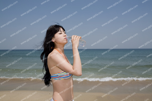 해변가에 비키니 여성이 물 마시는 모습 이미지 미리보기