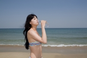 해변가에 비키니 여성이 물 마시는 모습 템플릿